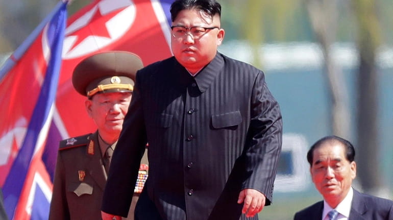 North Korean leader Kim Jong Un, center, is accompanied by...
