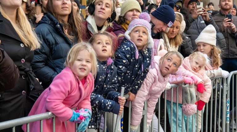 Children and adults alike wait to catch a view of...