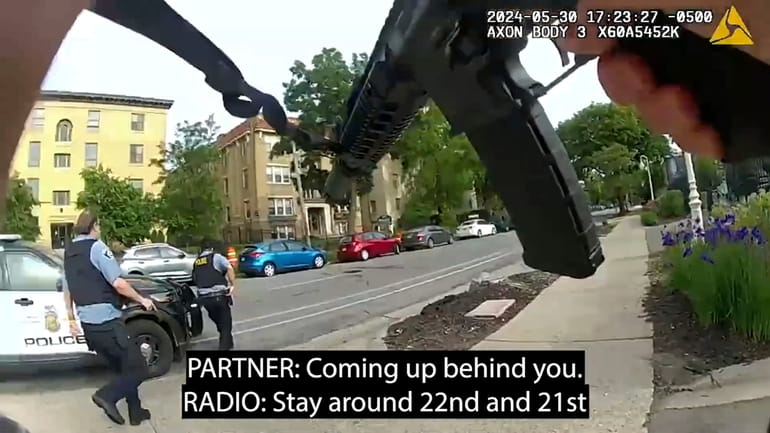 Frames from body-camera video released show officers responding to a...