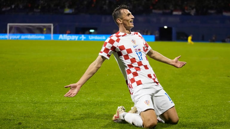 Croatia's Ante Budimir celebrates after scoring against Armenia during the...