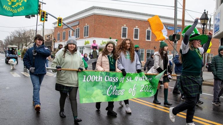 Members of the St. Patrick School Class of 2022 march down Main...