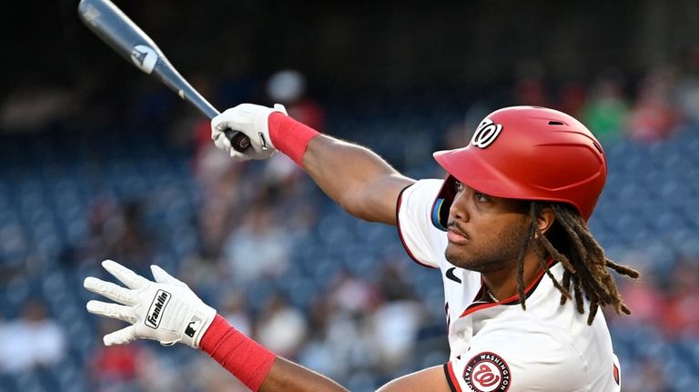 Washington Nationals' James Wood follows through on a double during...