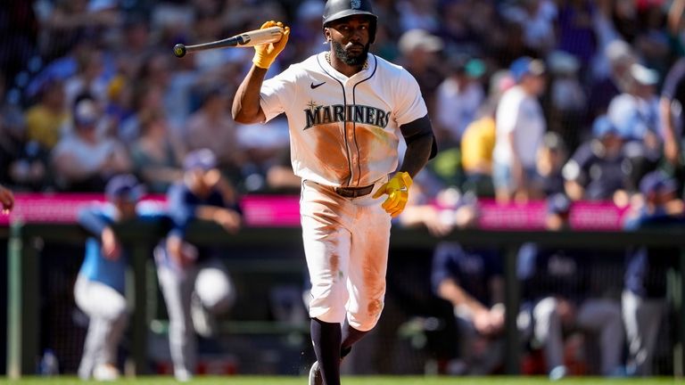 Seattle Mariners' Randy Arozarena tosses his bat after hitting a...