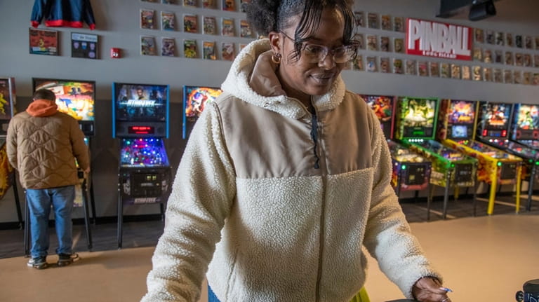 Kristyl Whitehead tries out one of the machines at Pinball...