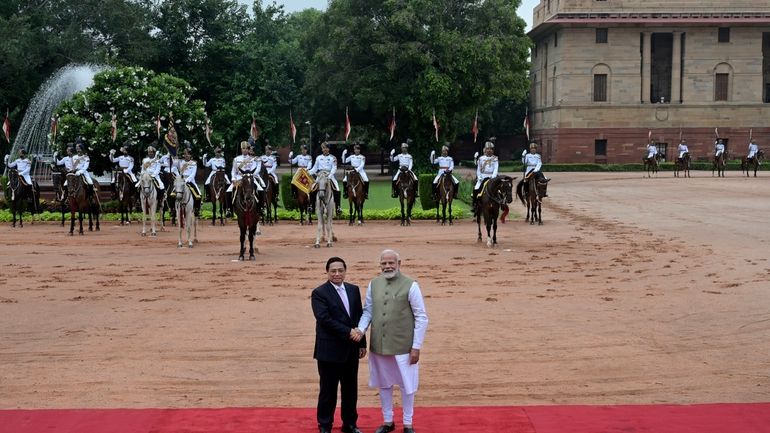 Indian Prime Minister Narendra Modi, right, receives his Vietnamese counterpart...