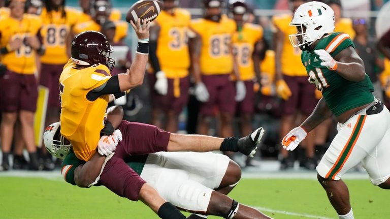 Miami linebacker Malik Bryant tackles Bethune-Cookman quarterback Luke Sprague during...