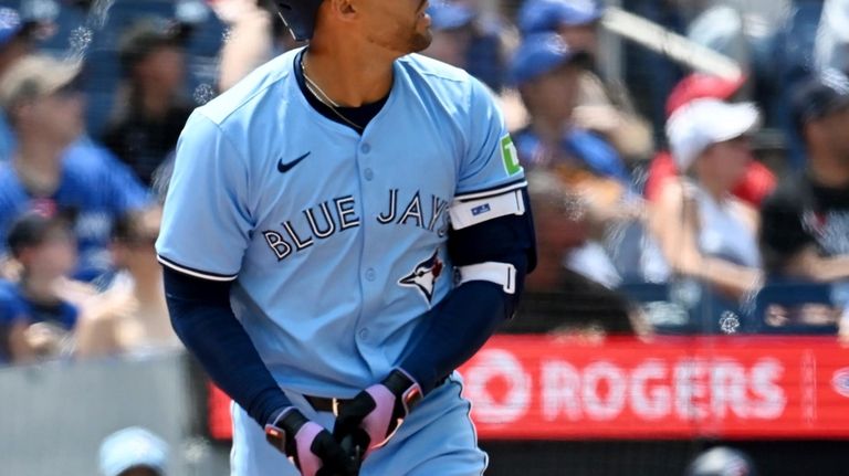 Toronto Blue Jays' George Springer watches his solo home run...