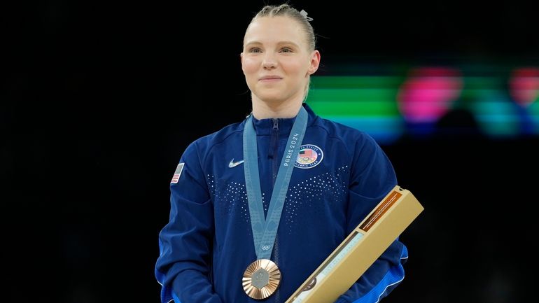 Jade Carey, of the United States, celebrates after winning the...