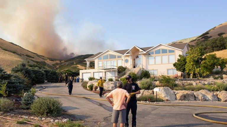 A Salt Lake City firefighter tells a local resident to...