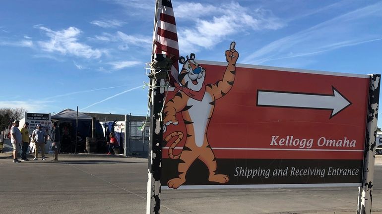 Striking Kellogg's workers stand outside the company's cereal plant in...