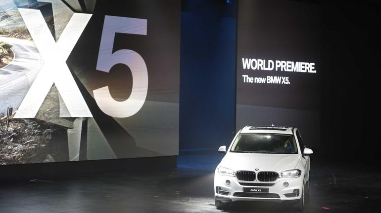 The BMW X5 rolls onto the stage during its world...