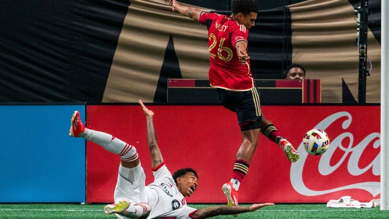 Toronto FC midfielder Jahkeele Marshall-Rutty, left, reacts as Atlanta United...