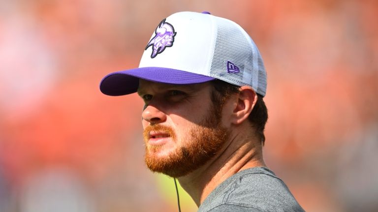 Minnesota Vikings quarterback Sam Darnold watches from the sidelines during...