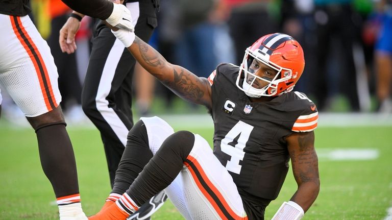 Cleveland Browns quarterback Deshaun Watson (4) is helped up by...