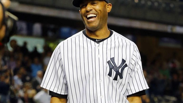 Mariano Rivera of the Yankees smiles after a pre-game gift...