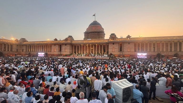 People watch as Narendra Modi takes oath as Prime Minister...