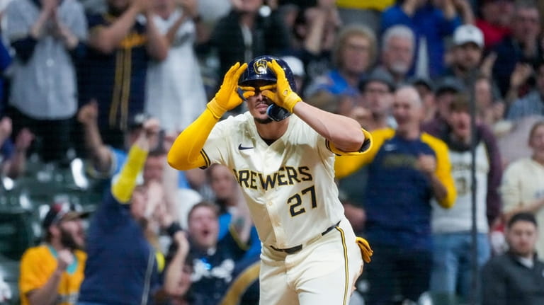 Milwaukee Brewers' Willy Adames reacts after hitting a two-run scoring...