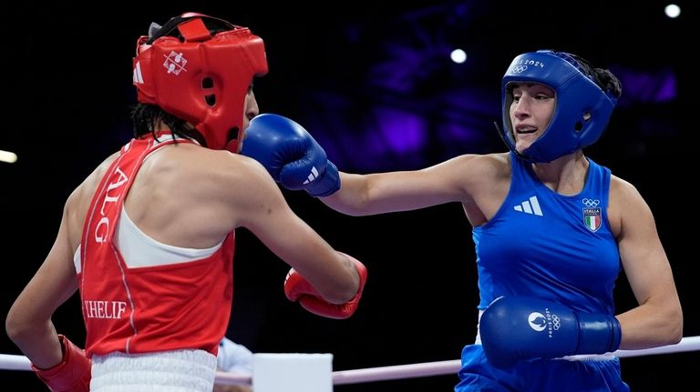 Algeria's Imane Khelif, left, fights Italy's Angela Carini in their...