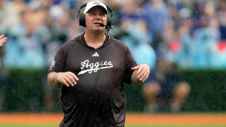 Texas A&M head coach Mike Elko walks on the sideline...