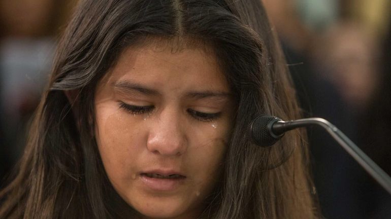 Mayeli Hernandez, 12, from Honduras, cries as she testifies before...