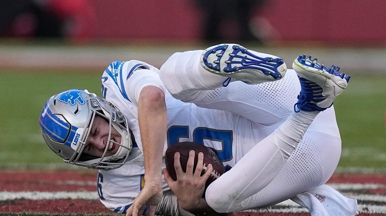 Detroit Lions quarterback Jared Goff hits the ground after being...