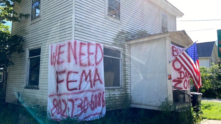 A sign asking for help from FEMA, Federal Emergency Management...