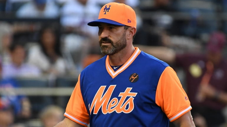 Mets manager Mickey Callaway walks to the dugout against the...