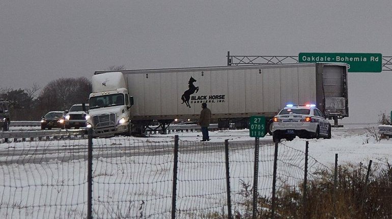 A jackknifed tractor trailer sits across westbound lanes of Sunrise...