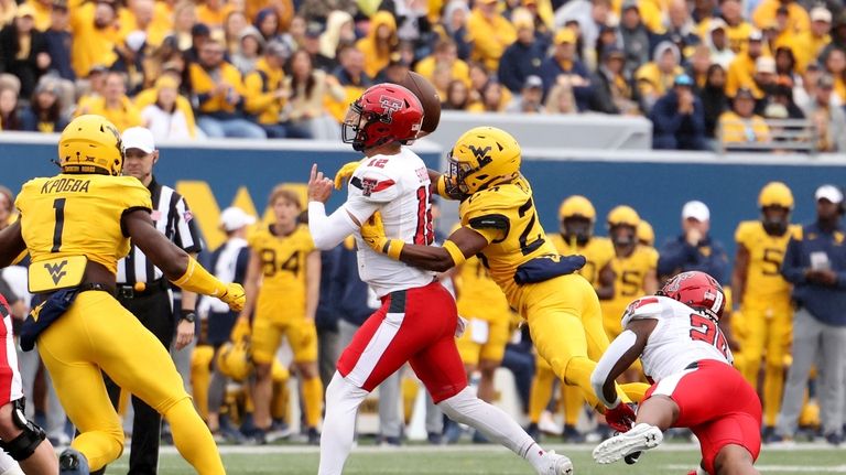 West Virginia Marcis Ford (24) goes to sack Texas Tech...