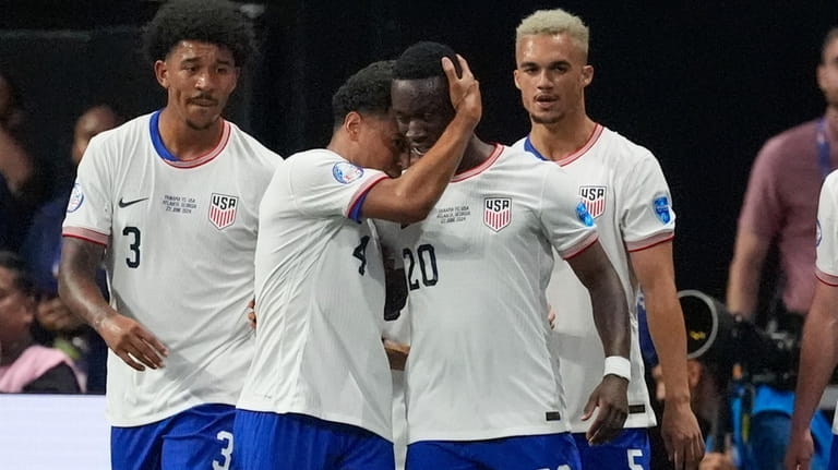 Folarin Balogun of the United States (20), celebrates with teammates...