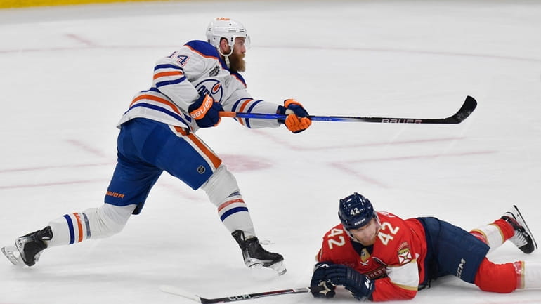 Edmonton Oilers defenseman Mattias Ekholm (14) scores during the first...