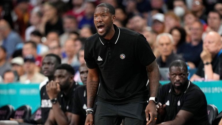 South Sudan head coach Royal Ivey yells to his team...