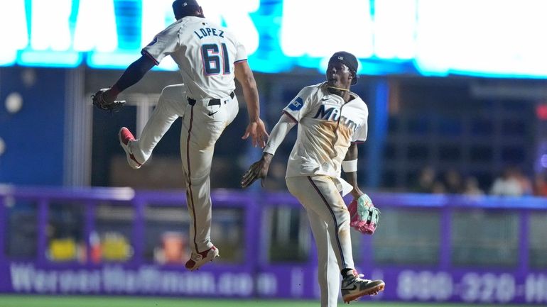 Miami Marlins second baseman Otto Lopez (61) and center fielder...