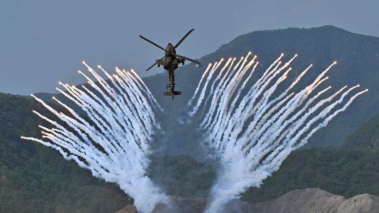 South Korea's Apache AH-64 helicopter fires flares during a South...