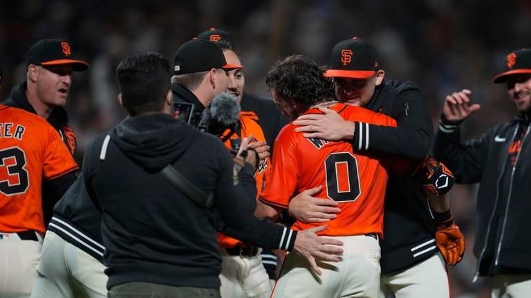 San Francisco Giants' Brett Wisely (0) is congratulated after hitting...
