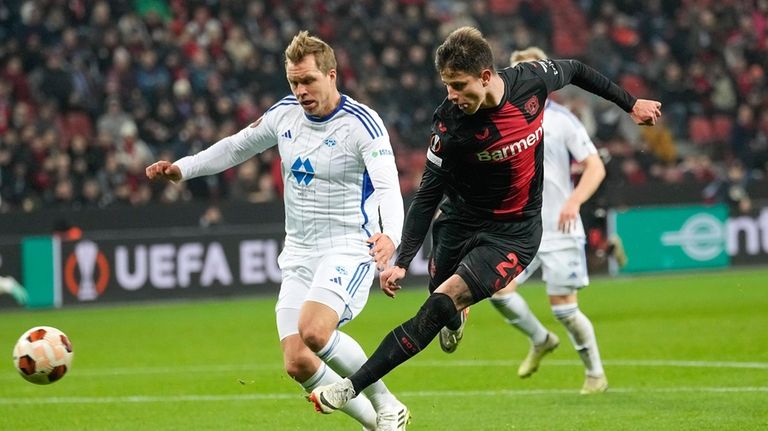 Leverkusen's Adam Hlozak, right, scores his side's 4th goal during...