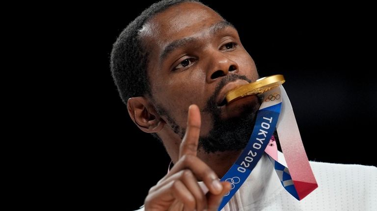 Kevin Durant poses for a photo with his gold medal...