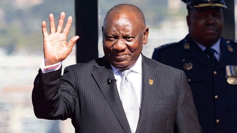 Cyril Ramaphosa waves as he arrives ahead of his inauguration...