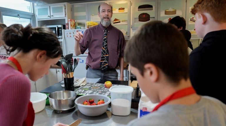 Scott Saffer instructs students during a cooking class, Thursday, May...