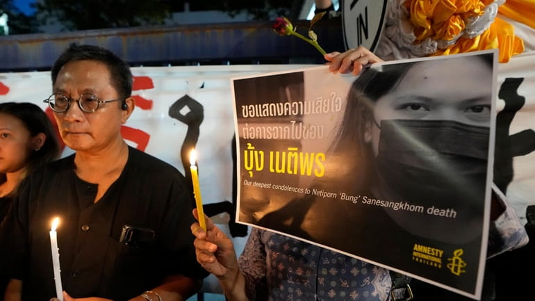 Thai activists hold a portrait of Netiporn Sanesangkhom, a member...