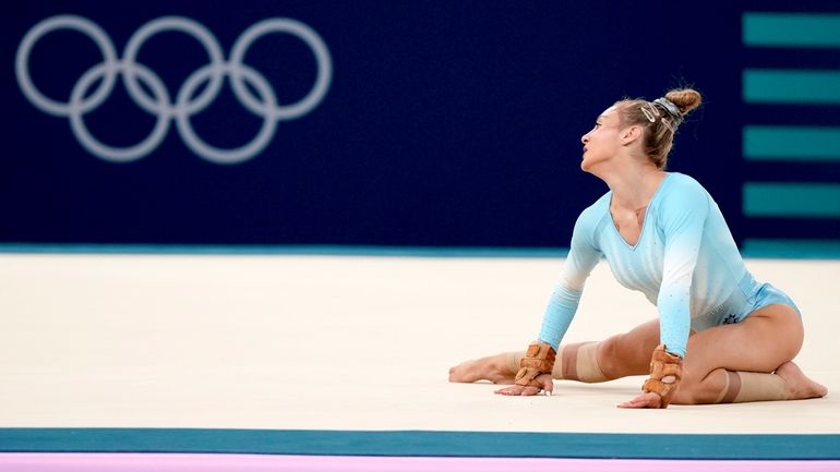 Sabrina Maneca-Voinea, of Romania, competes during the women's artistic gymnastics...