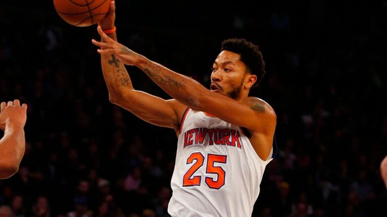 Derrick Rose of the New York Knicks passes the ball...