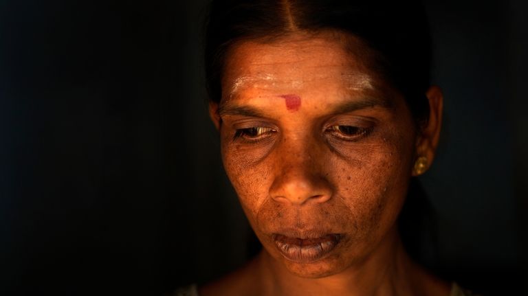 Muthuthewarkittan Manohari, a tea plantation worker, gets ready to go...