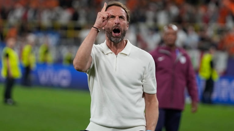 England's manager Gareth Southgate celebrates at the end of a...
