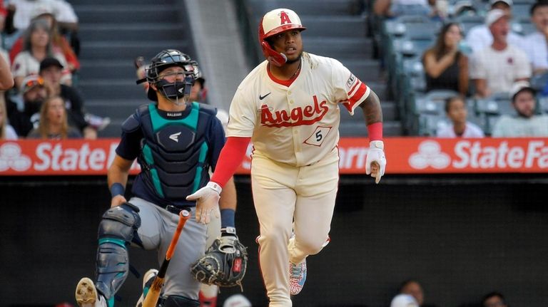 Los Angeles Angels' Willie Calhoun, right, heads to first for...