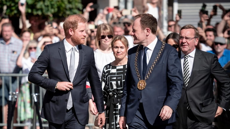 Britain's Prince Harry, front left, arrives with Duesseldorf's Lord Mayor...
