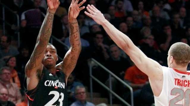 Cincinnati's Sean Kilpatrick (23) shoots over Syracuse's Brandon Triche during...