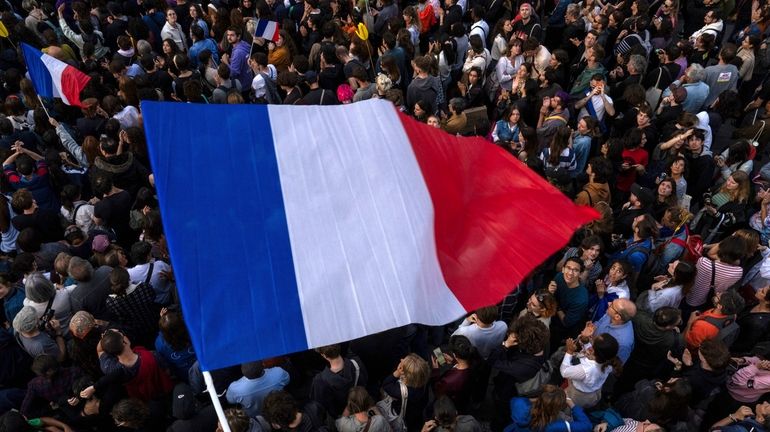 People gather at Republique plaza in a protest against the...