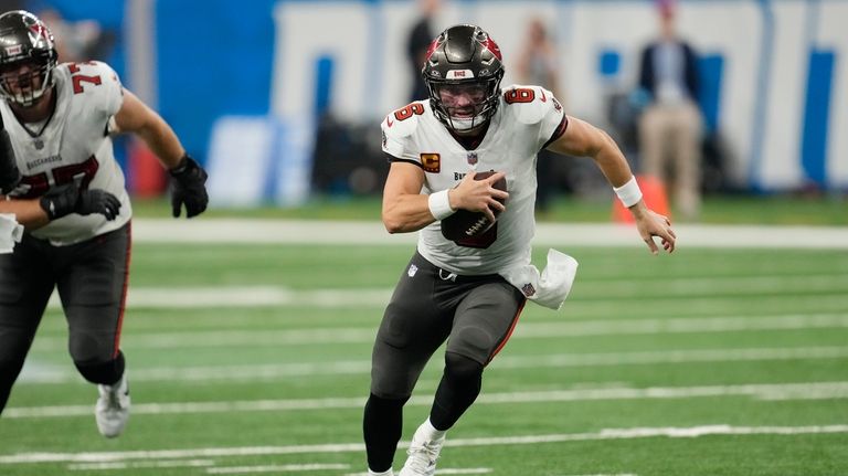 Tampa Bay Buccaneers quarterback Baker Mayfield scrambles for a 11-yard...