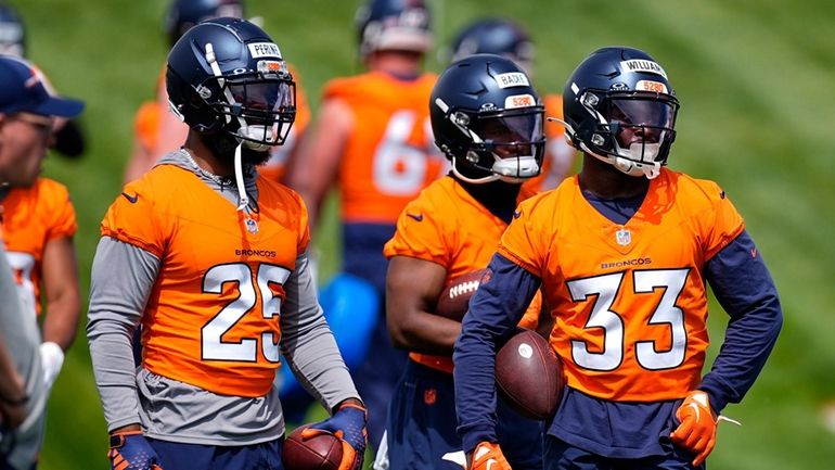 Denver Broncos running backs, from left, Samaje Perine, Tyler Badie...